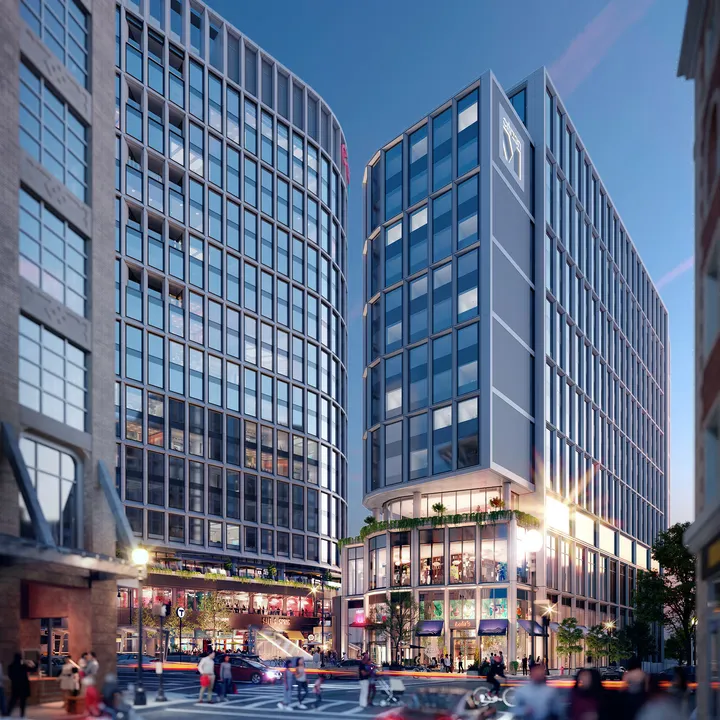 Evening view of The Lyrik Back Bay development with illuminated facades and pedestrian areas