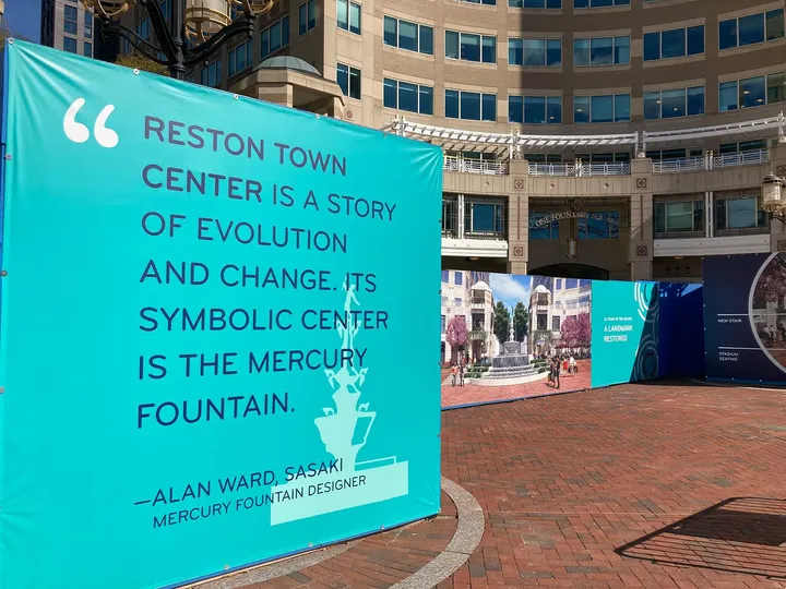 Photo of fountain banner from different angle showing pedestrian interaction
