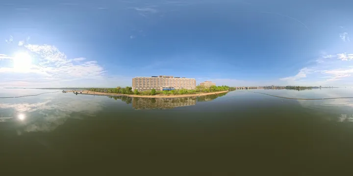 Full 360-degree view of the Parexel building on its waterfront site, with water and a bridge visible on both sides.